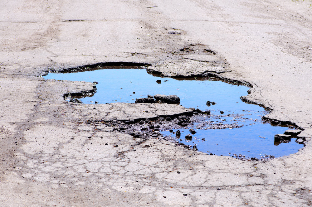Asphalt Maintenance, Pothole needs repair in driveway.