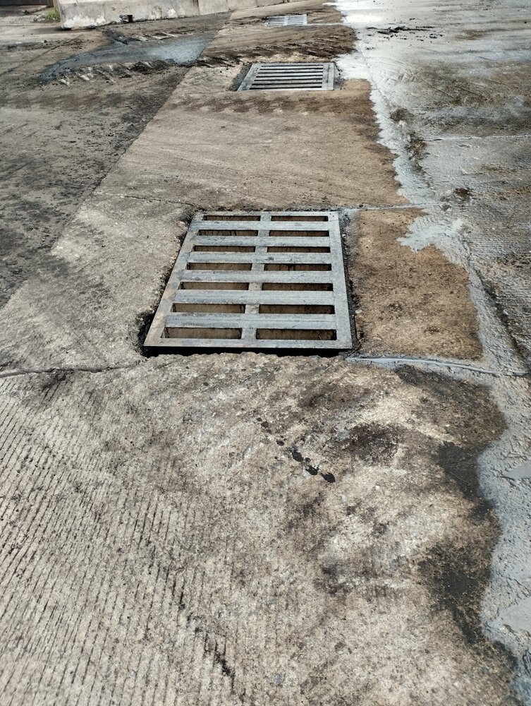 Asphalt Draining. Safety Of Metal Water Drain Holes On The Road Surface.