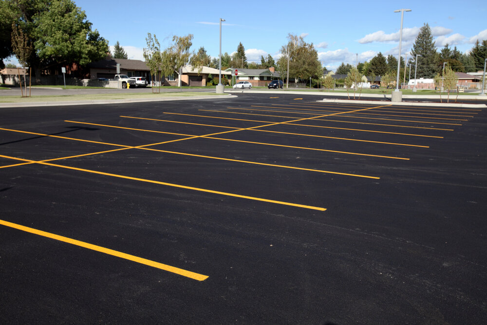 Parking Lot Space. A Newly Completed Parking Lot With Freshly Painted Yellow Lines.